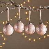 Four Kecci antique pink etched glass baubles hanging from a branch