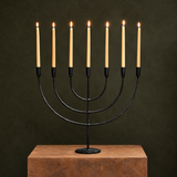 Nkuku Mbata seven-arm candelabra in antique black, framed prominently