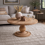 Laya natural mango wood coffee table with its full carved pedestal base