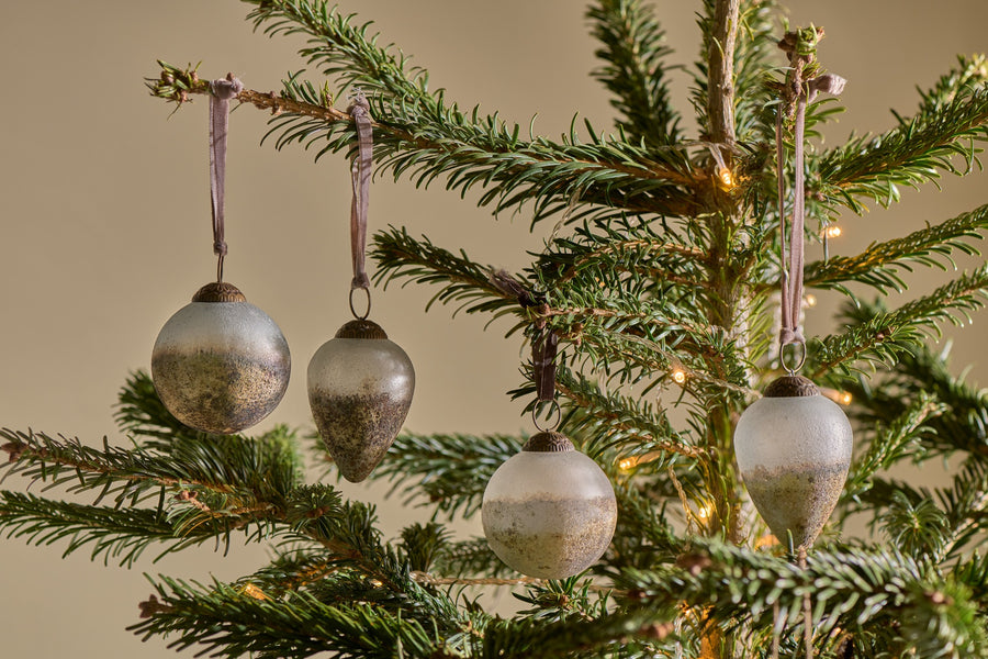 Golden glass baubles nestled amongst festive greenery