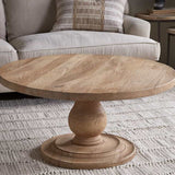 Nkuku Laya round carved coffee table in natural mango wood